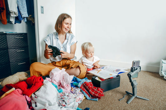 Folded pile of premium pre-loved children's clothing ready to be sold through a sellback program 