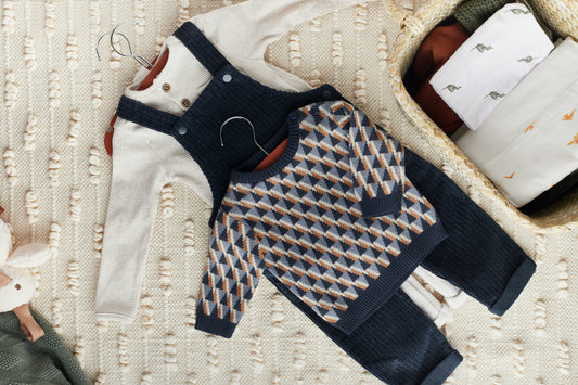 Folded Petit Bateau, Jacadi, and Bonpoint children's clothing on a neutral background, ready for resale